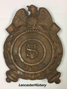 Metal marker with eagle at top and SV in center
