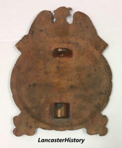 Metal marker with loop at top and bottom.