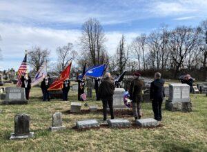Men facing honor guard and saluting