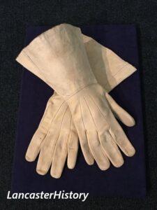 Pair of white leather gauntlets